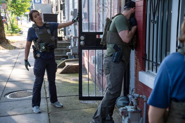 Deputy U.S Marshals at entrance of residence during…