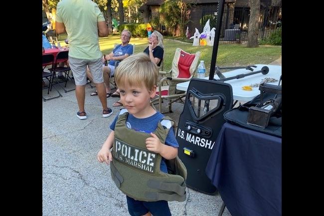 Child wearing deputy U.S. Marshal vest at 2022 National…