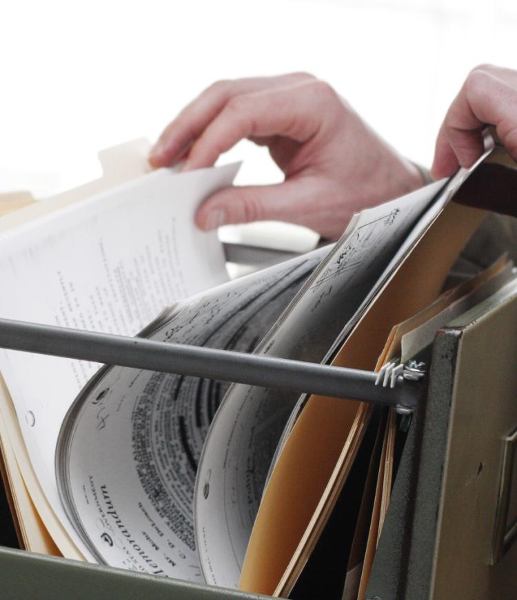 a hand with lots of papers