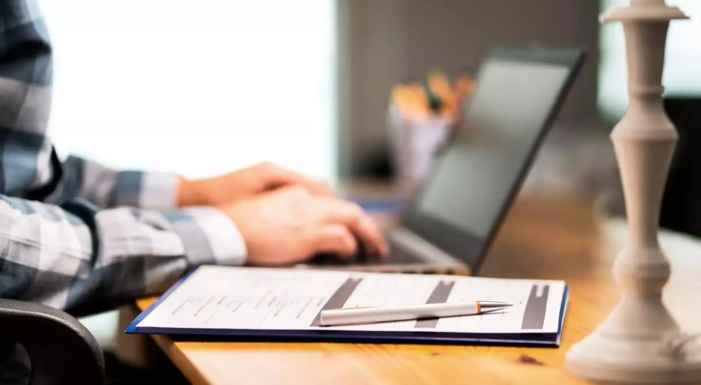 A laptop and a paper on a desk