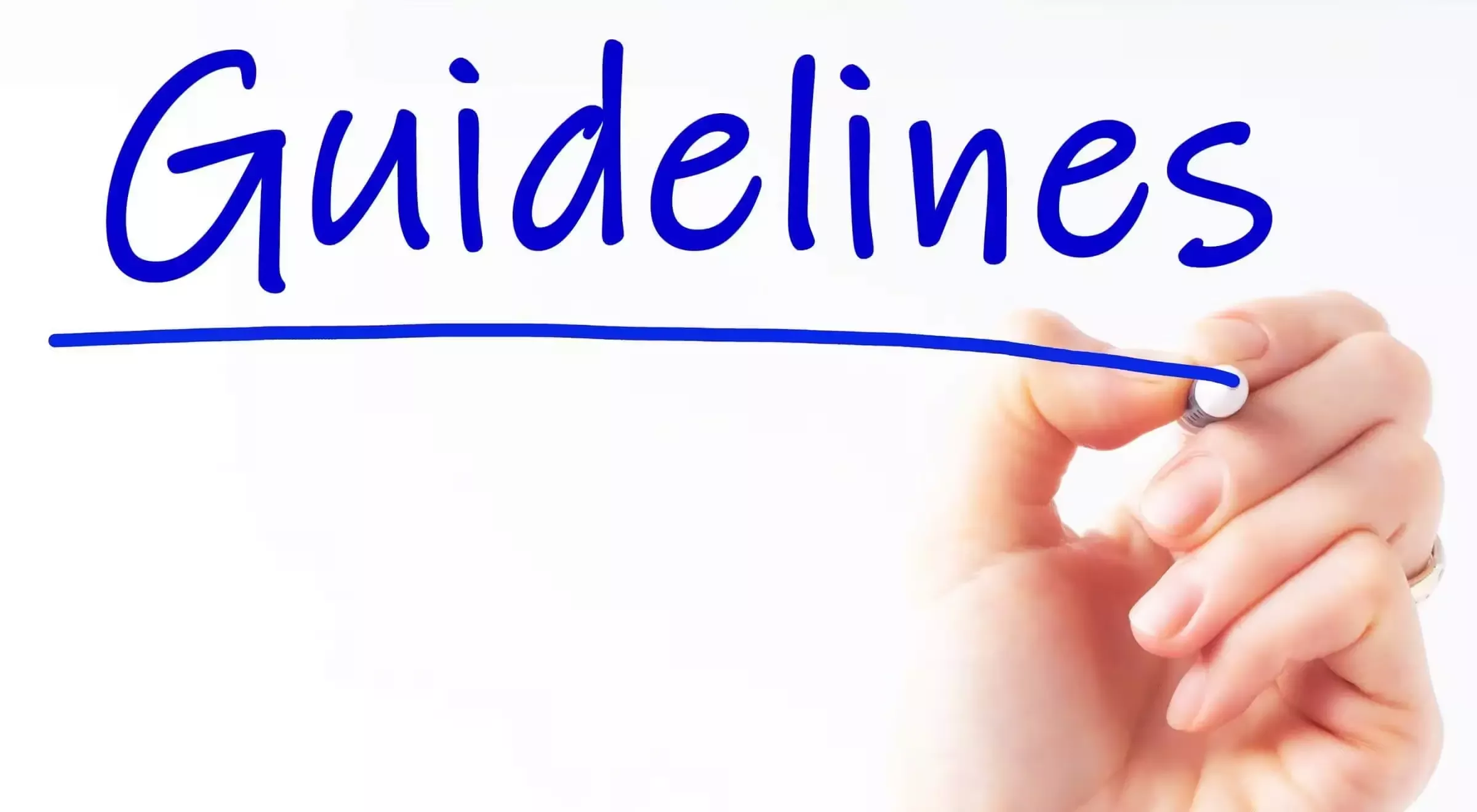 A hand writing the word Guildeline